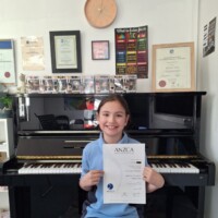 female student holding ANZCA exam result