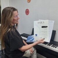 teacher holding ANZCA exam result