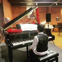 male kid on the piano