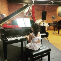 female kid on the piano