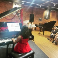 girl playing piano in the crowd