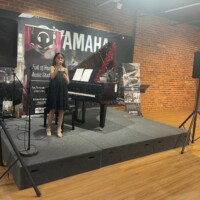 girl in black dress singing