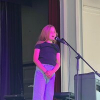 girl singing on stage