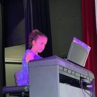 girl having a piano recital close-up